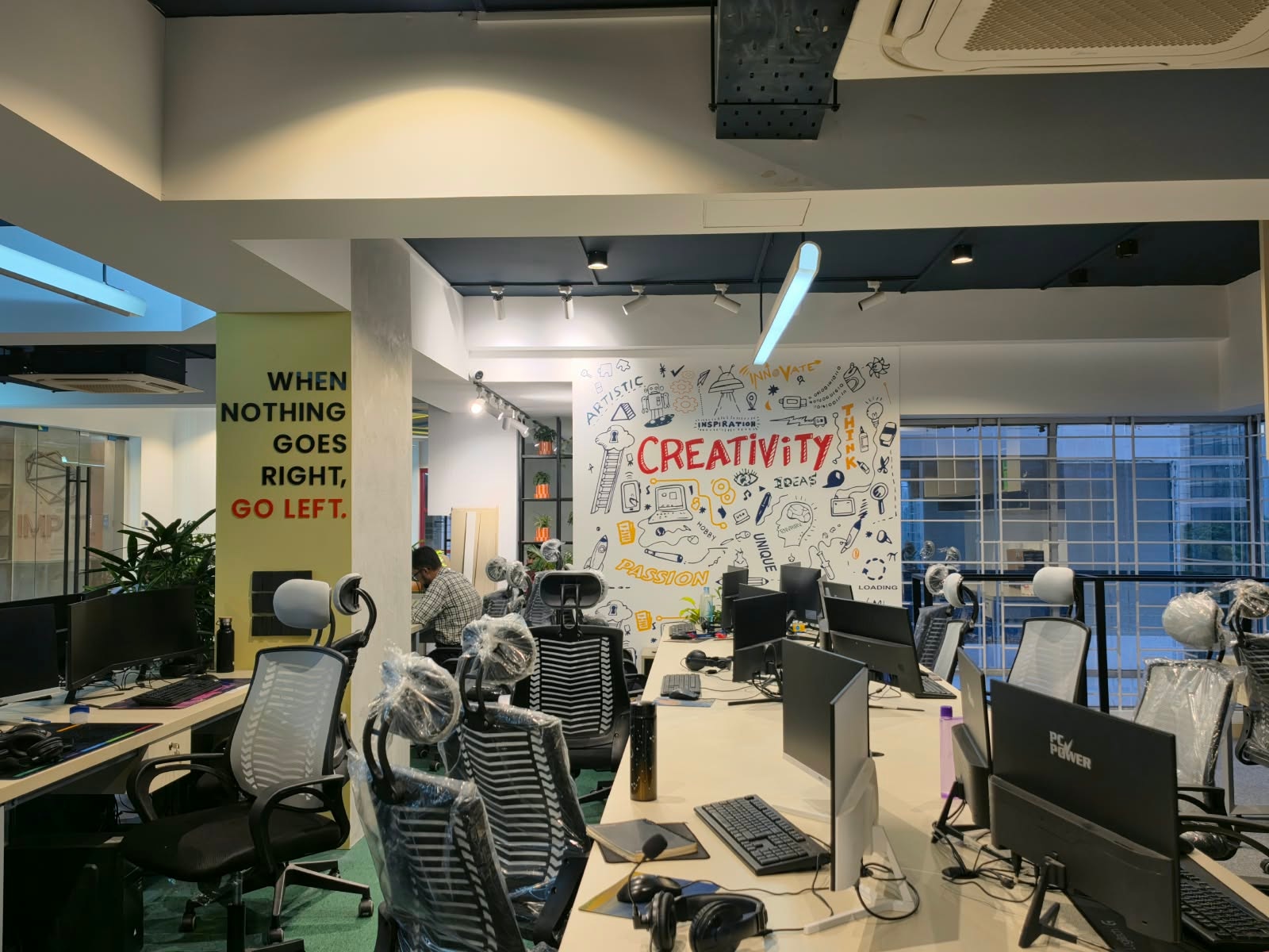 IMPIT workstations beside the Creativity mural