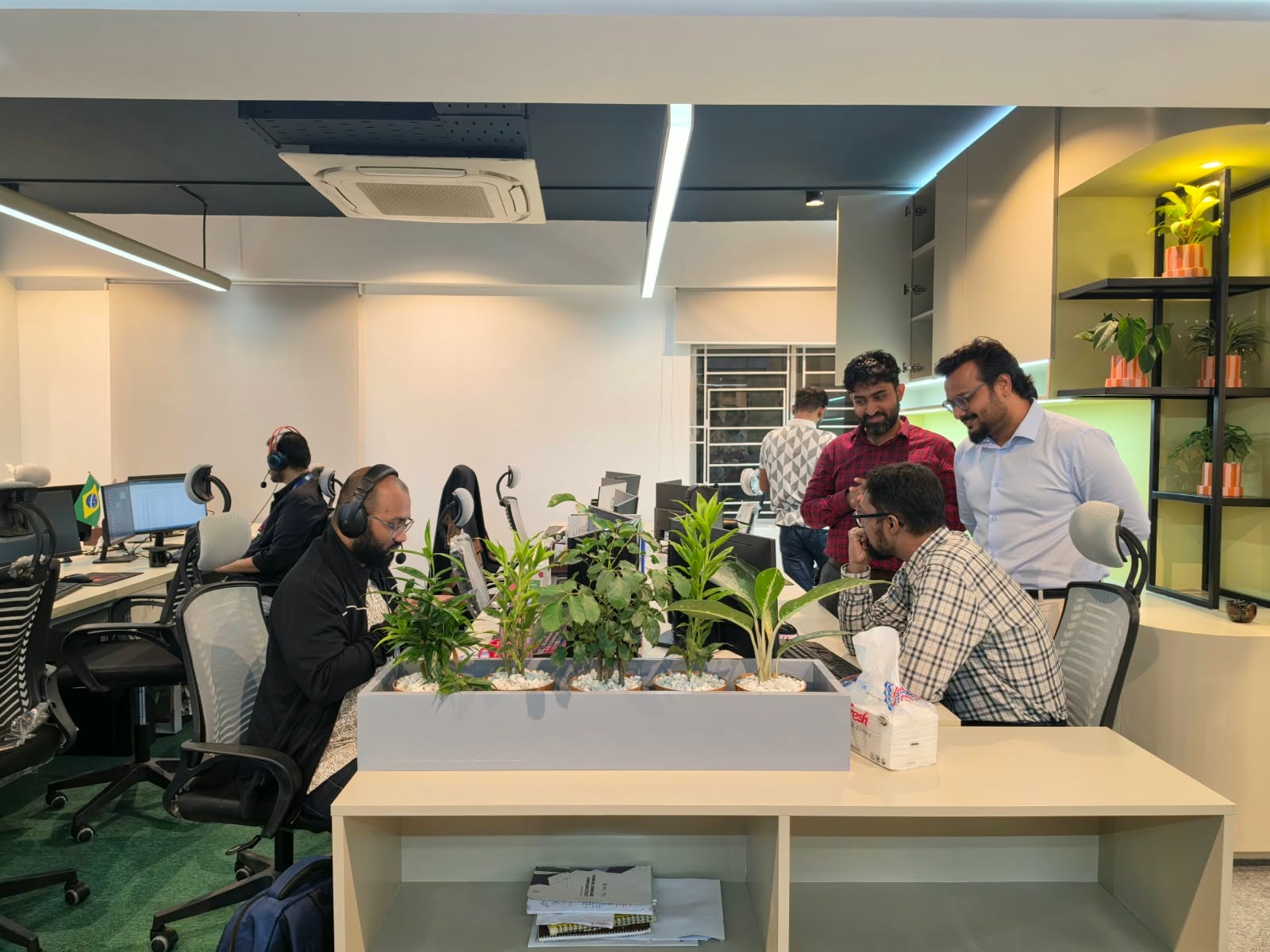 IMPIT team lead coordinating with a colleague at his desk on the operations floor