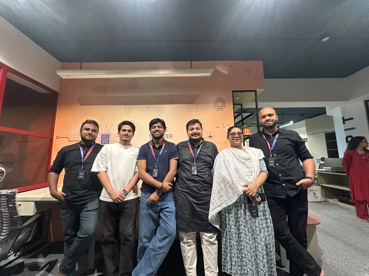 IMPIT team standing together inside the new office