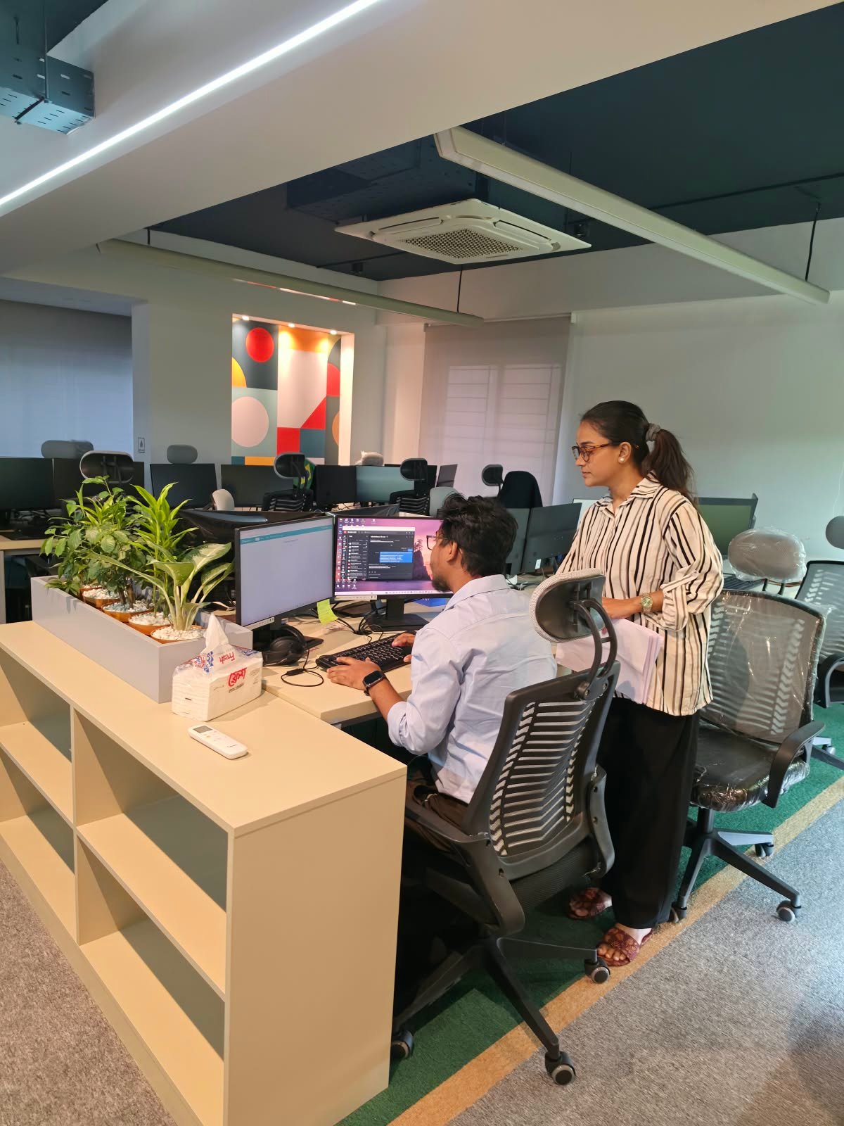 IMPIT colleagues aligning on intake and delivery standards at a desk